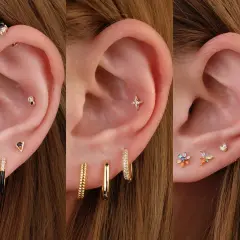 Ucho z kilkoma kolczykami, w tym błyszczącym helix piercingiem, gwiazdką i kolorowymi kamieniami.